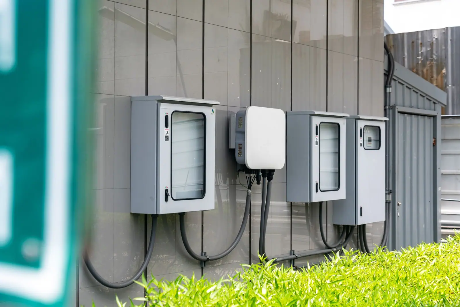 Electrical utility boxes with cabling on the outside of a building