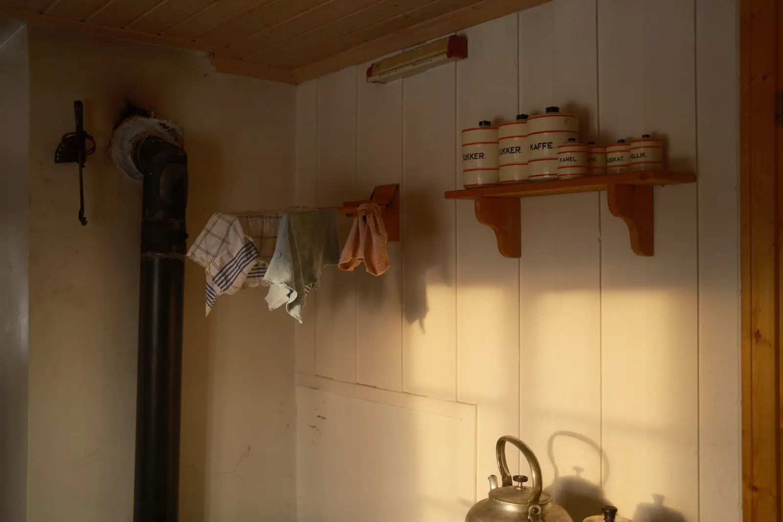 A metal flue pipe running up the wall of a rustic kitchen