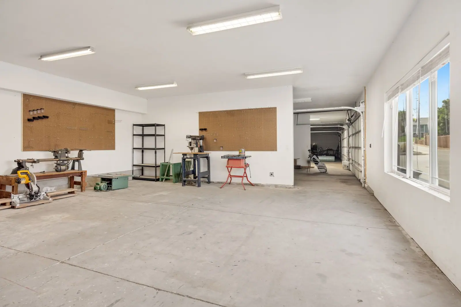 A bright workshop with machinery and tools along the walls