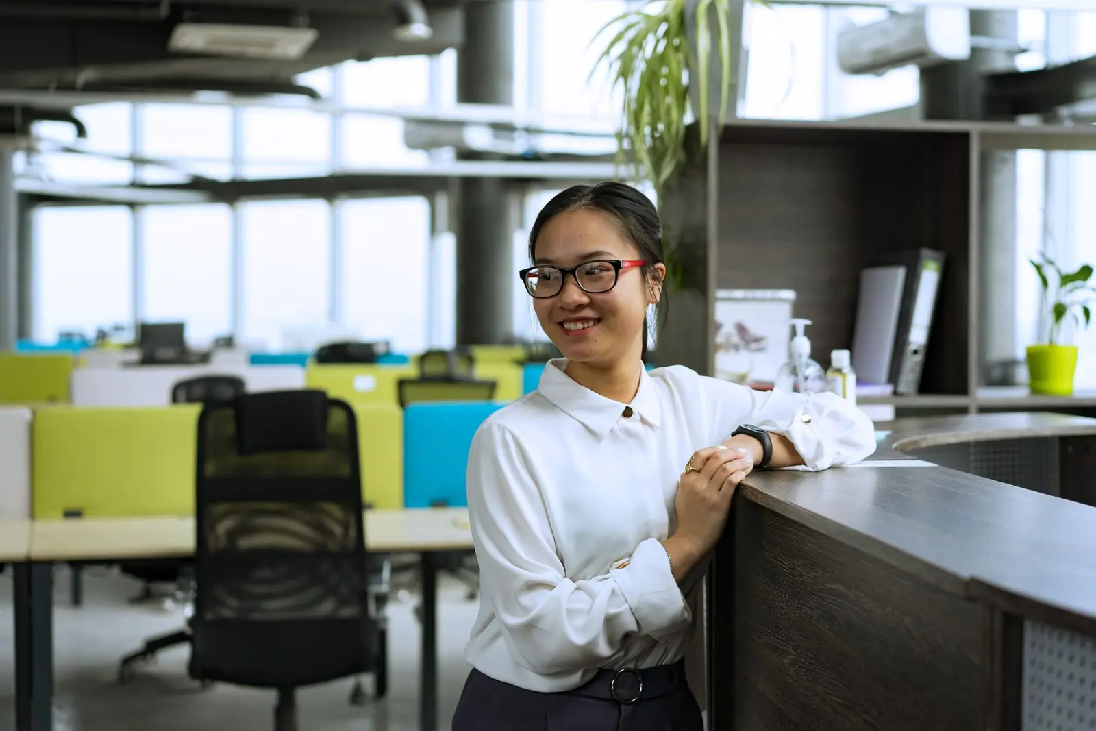A person standing at a reception desk in an office