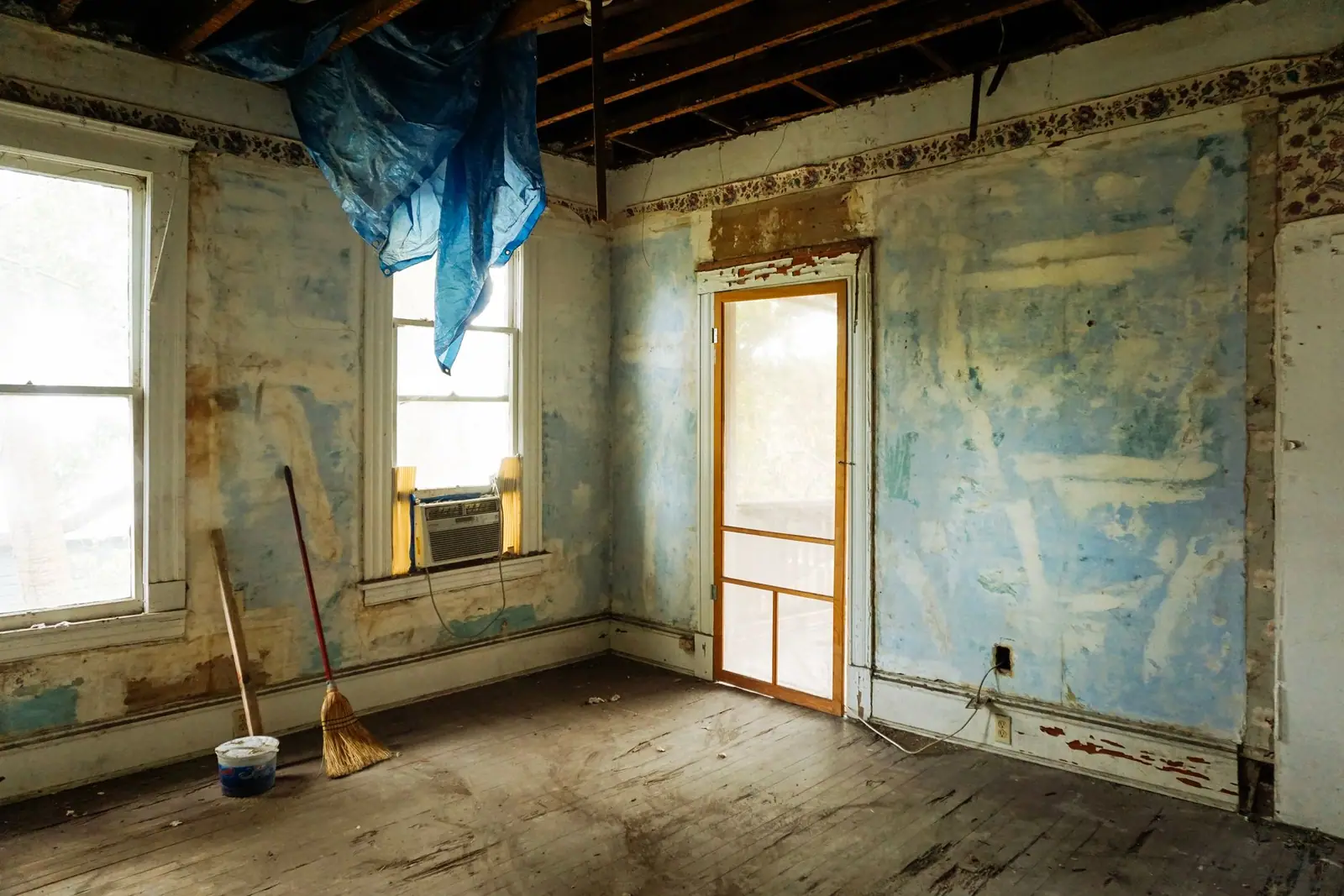 A room stripped back to bare walls during renovation