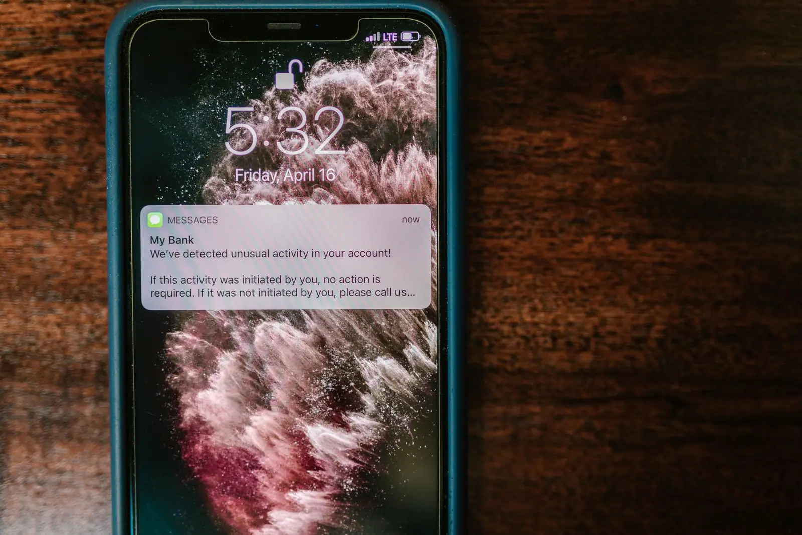 A phone on a table showing an account alert notification